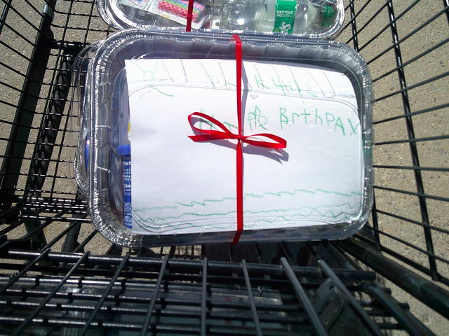 Three birthday cake kit in a shopping cart.